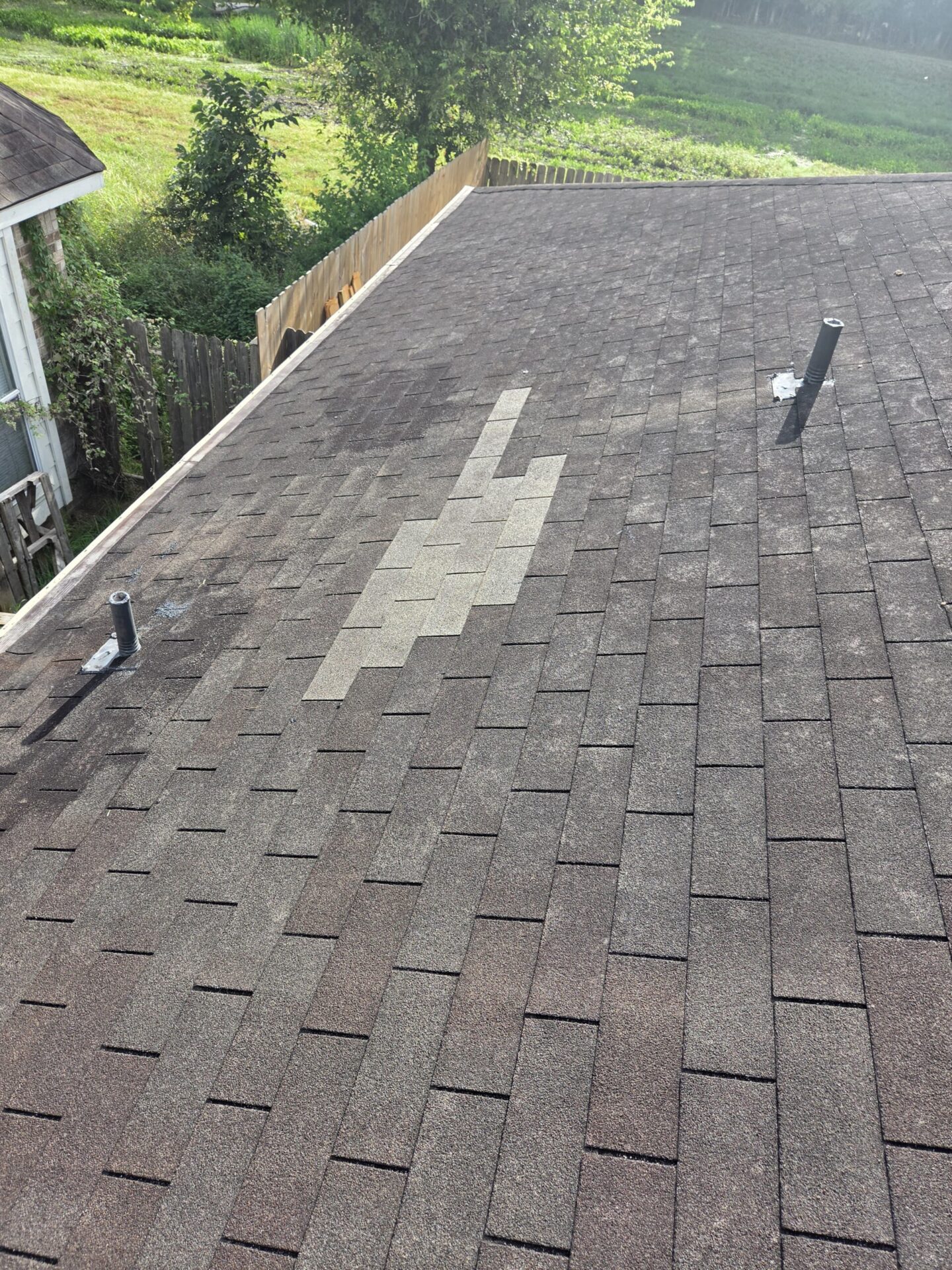 Weathered asphalt shingle roof section on a Fort Bend County home that may need replacement