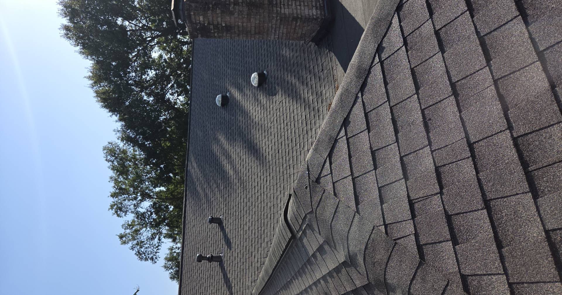 Roof surface being inspected before coating in Fort Bend County